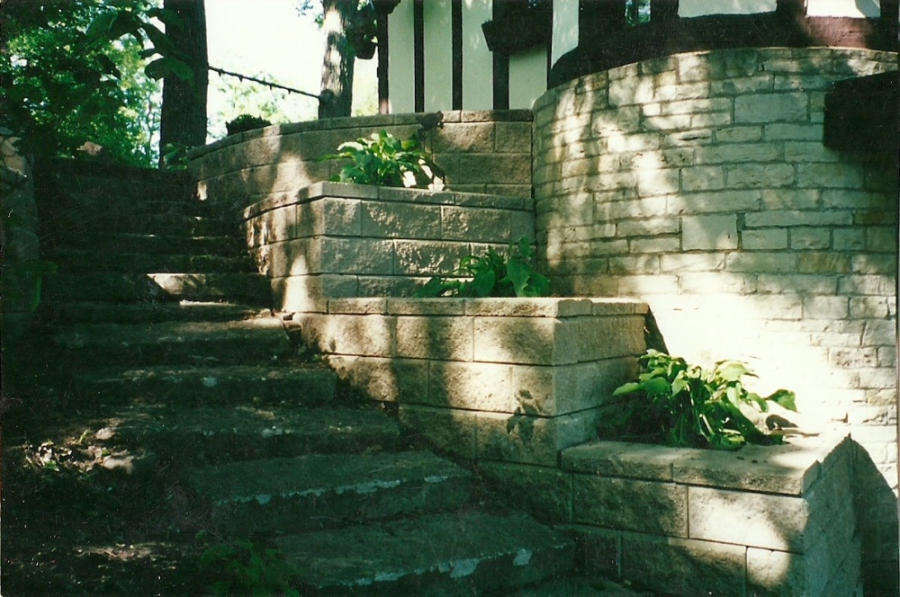Stone steps lead up a rounded retaining wall